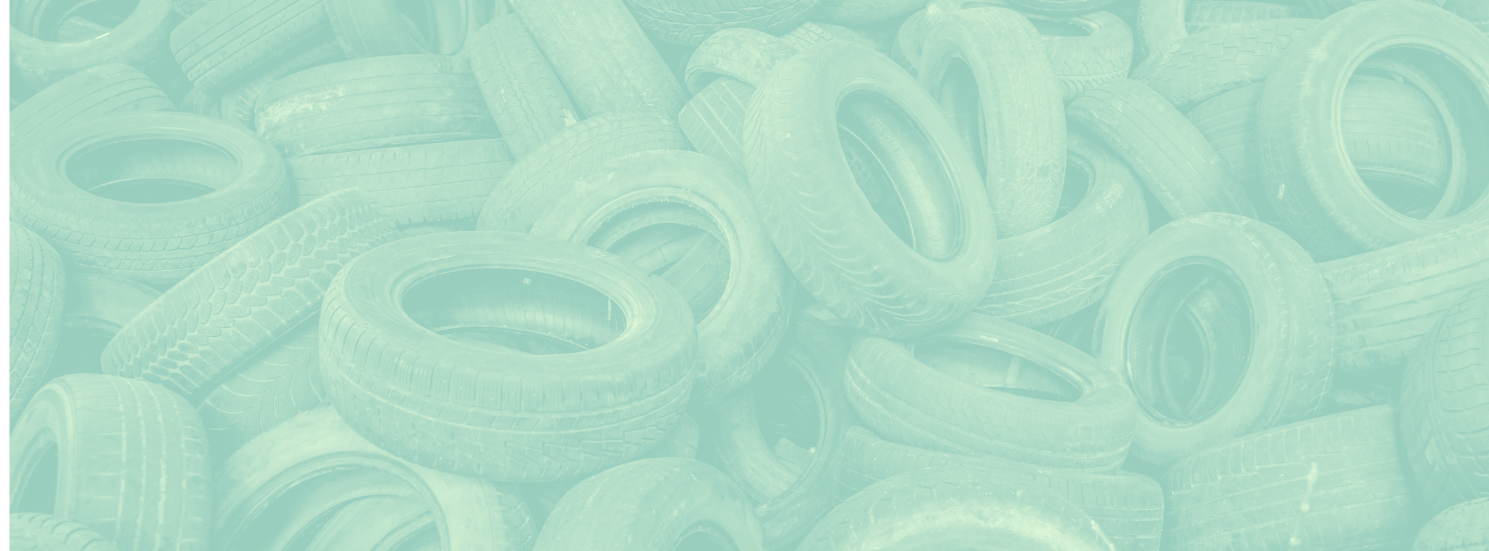 Loose pile of used tyres in a light mint tone